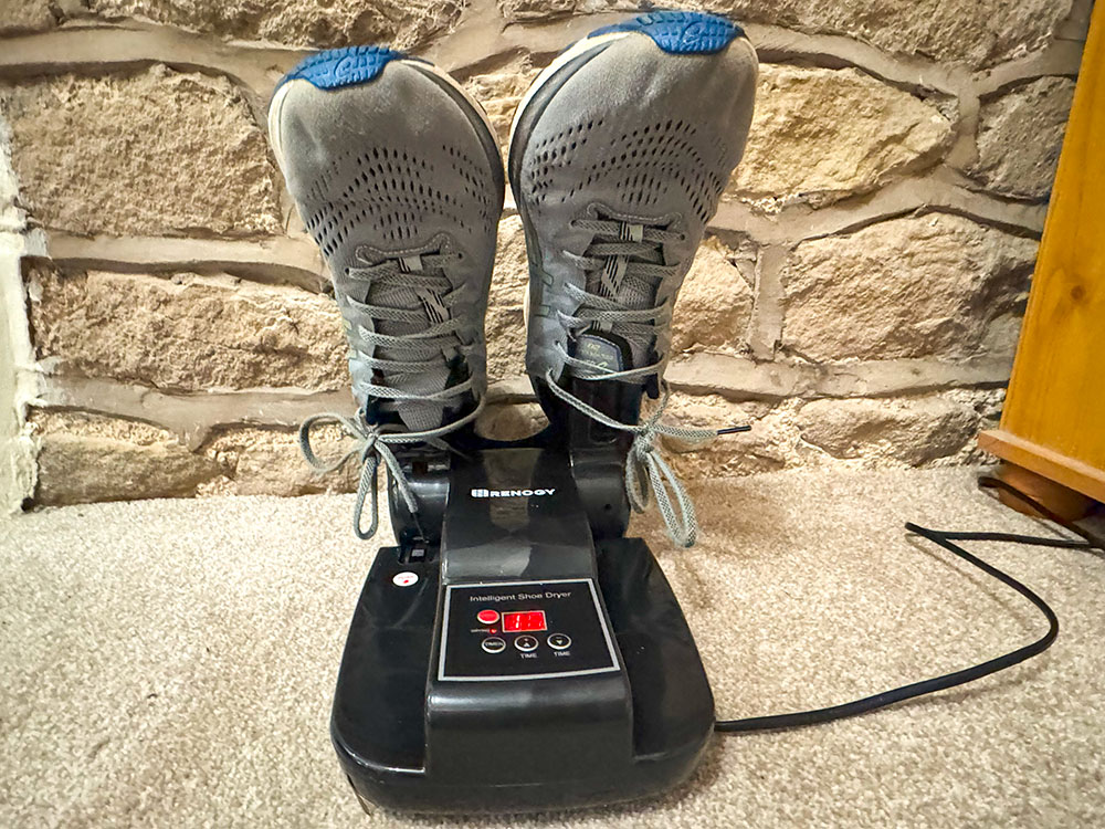 Running shoes drying on an electric boot dryer