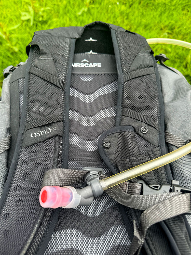 Magnetic catch on hydration tube connected to sternum strap on Osprey backpack