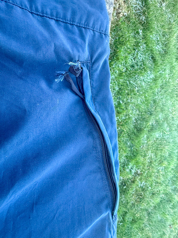 Pocket with a storm flap on waterproof trousers