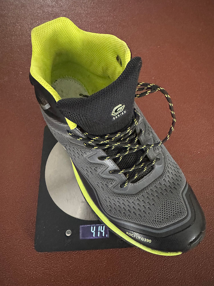 A lightweight synthetic hiking boot on a scale, weighing 0.8kg for the pair