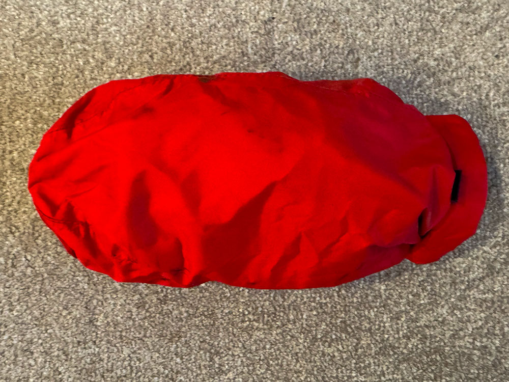 The waterproof trousers packed into a small drybag