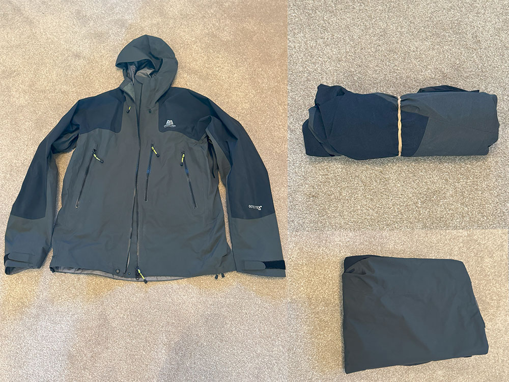 Waterproof jacket laid out rolled up and folded