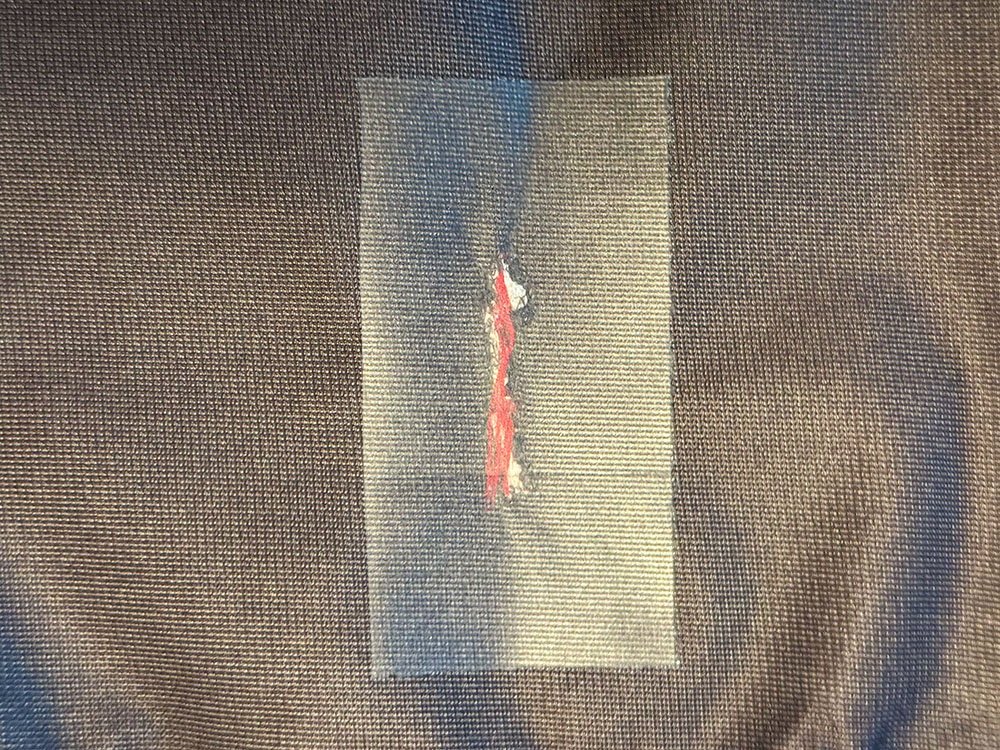 Small tear sealed with Gear Aid repair tape from the inside