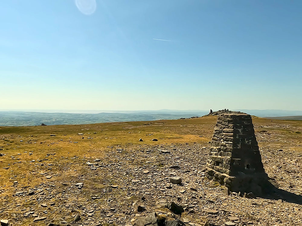 Looking out towards Morecambe Bay and the Lakeland Fells from the trig point on Ingleborough