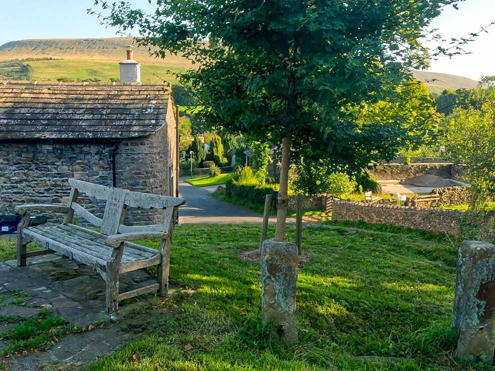 The base of the old Downham Stocks with Pendle Hill in the background