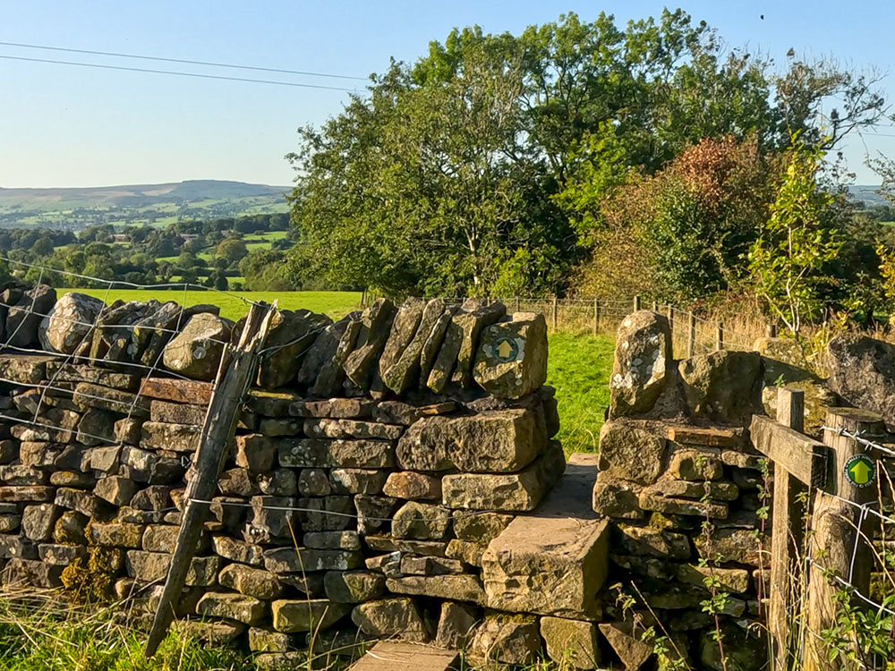 Head over another stile and keep on alongside the fence