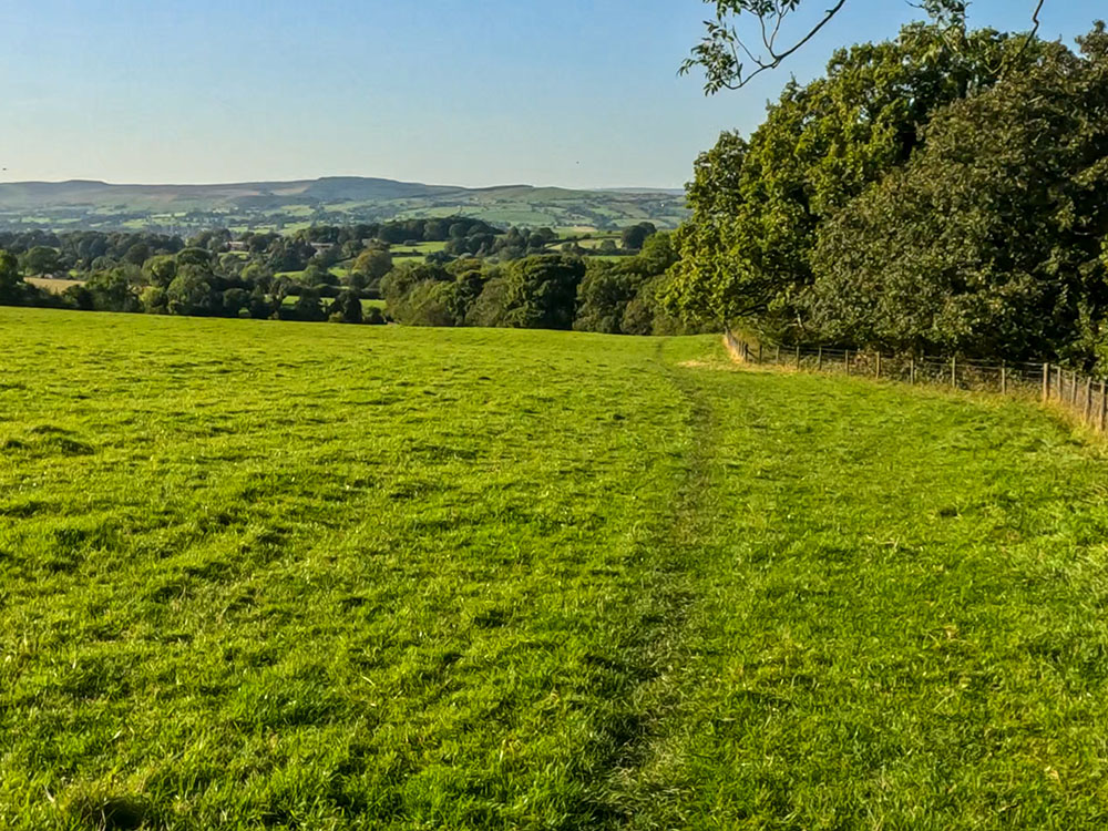 The path alongside the fence heading down towards Clay House