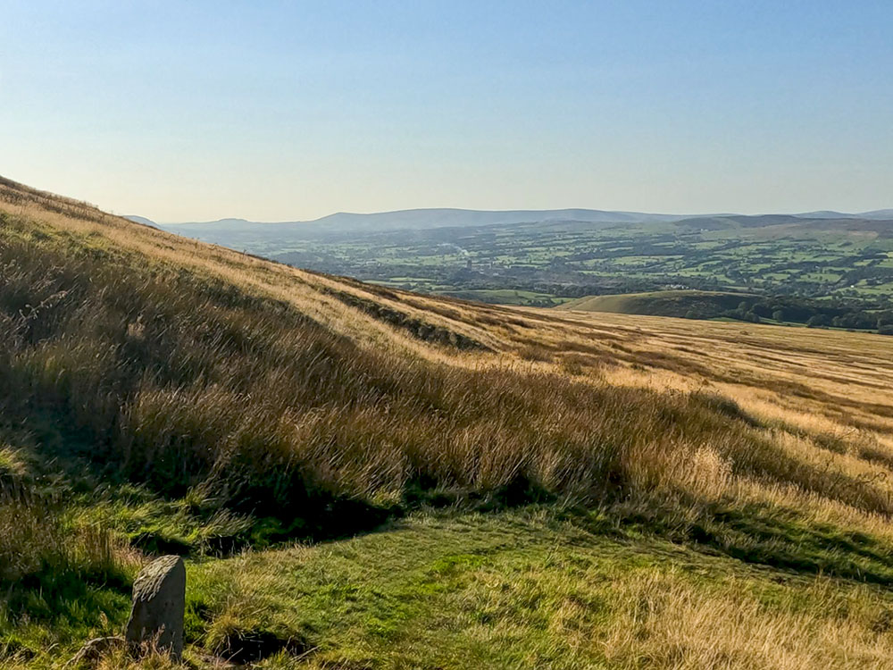 After 'zagging' back, the path heads around to the right, heading directly away from the hill at the next stone marker