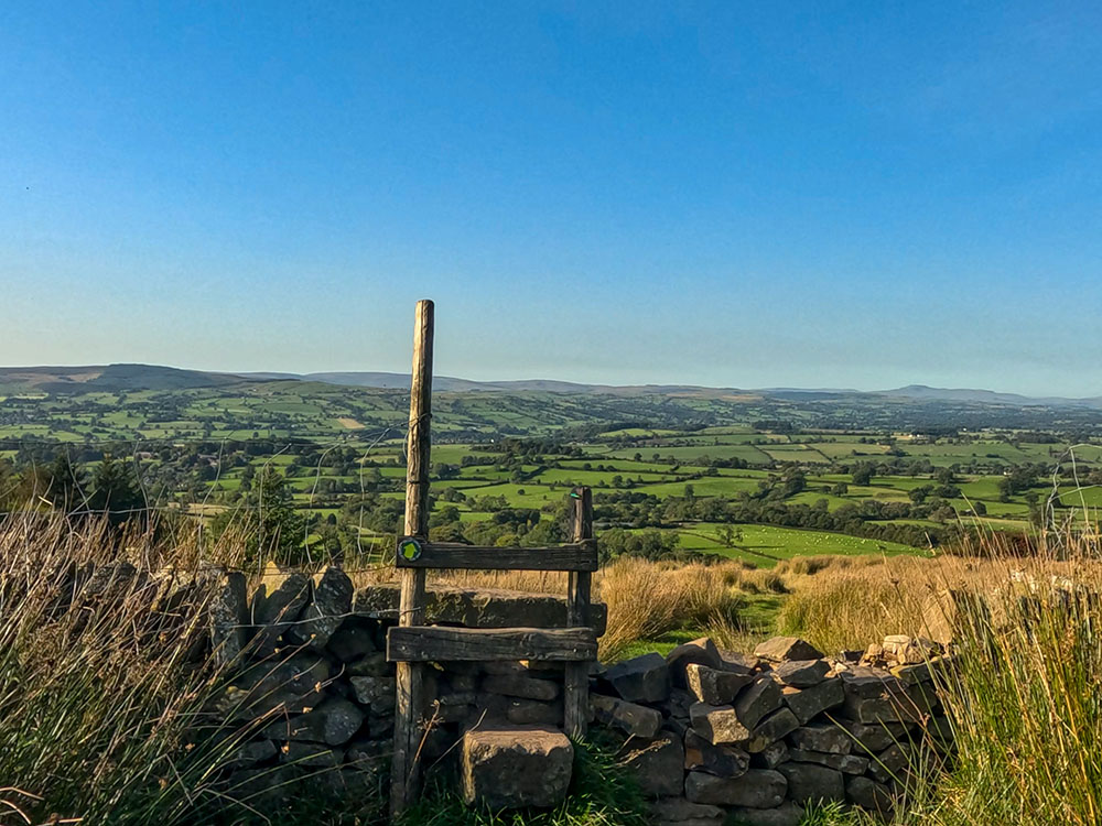 The path heads over the next stile and continues downhill