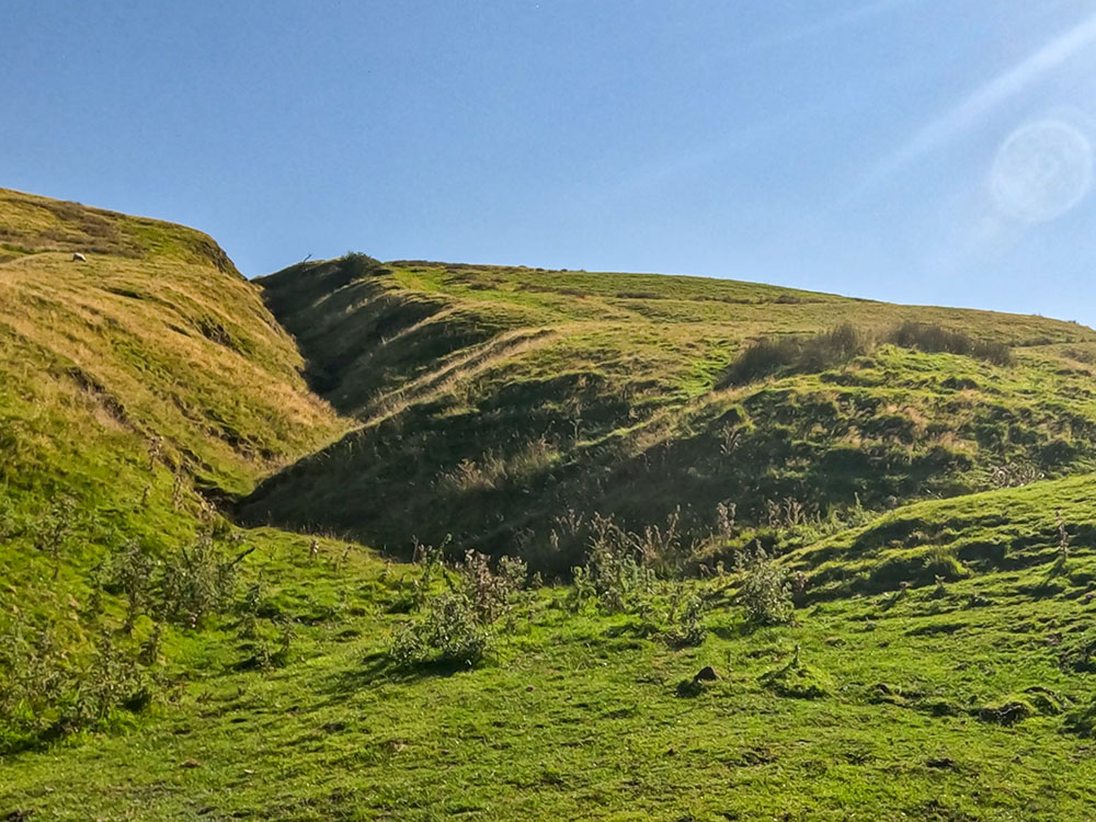 The path heads up the right-hand side of Burst Clough