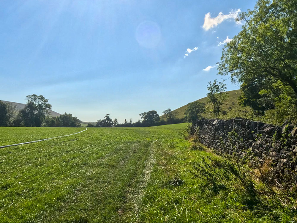 The path leaves the wall at the wall corner to head across the field