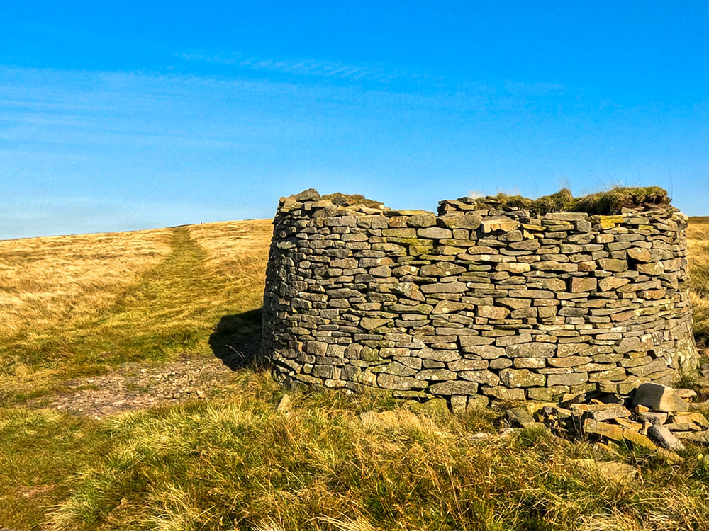 The path passing by the weather shelter on Pendle Hill