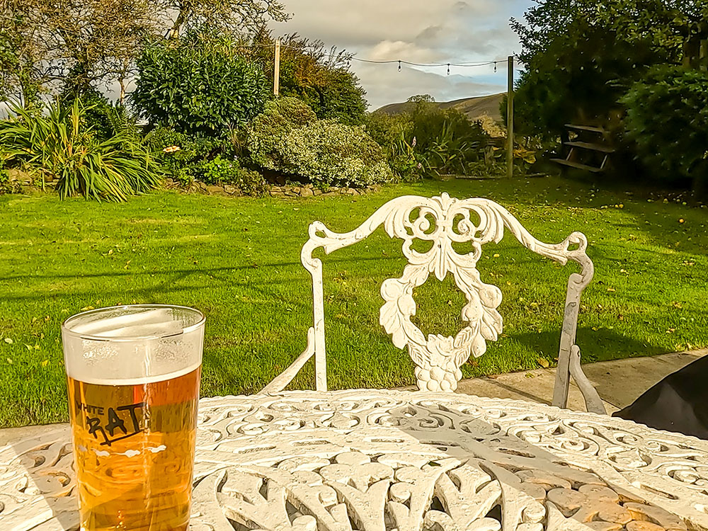 Enjoying a drink in the beer garden at the Swan with Two Necks in Pendleton, looking towards Pendle