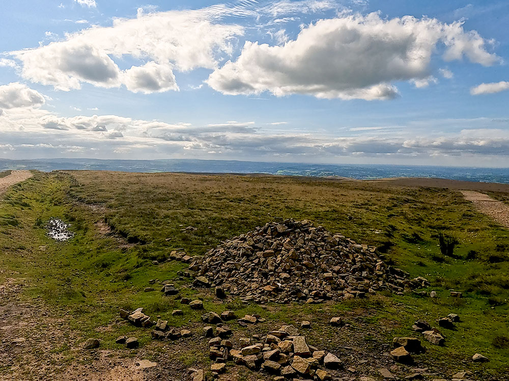 Looking back from the triangulation point on the summit of Pendle Hill down the path walked up on the right and the path towards Ogden Clough on the left