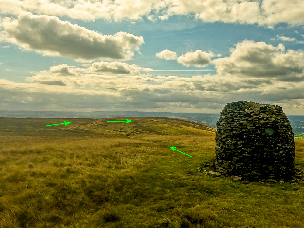 The Scout Cairn on Pendle Hill. The onward path heads down the left-hand side of the cairn and is visible ahead.