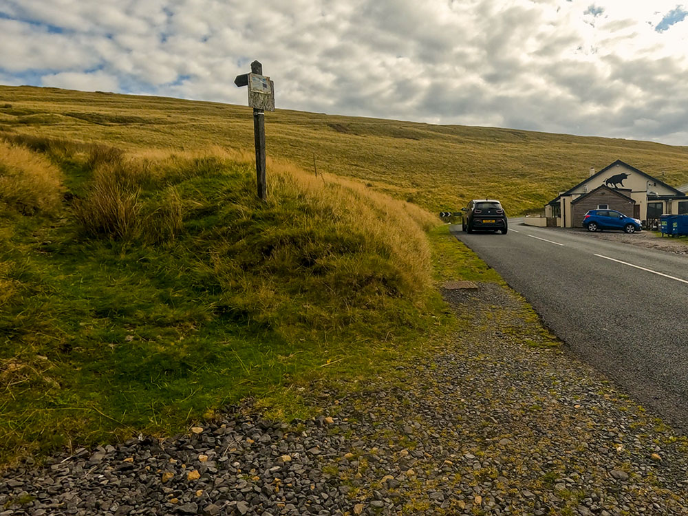 We follow the footpath sign opposite the Wellsprings to head diagonally away from the road uphill