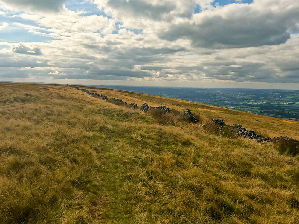 The path along the side of the tumbled-down wall