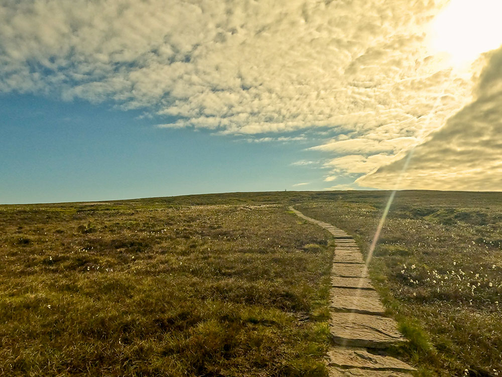 The paved footpath continues to climb across the desolate Barley Moor